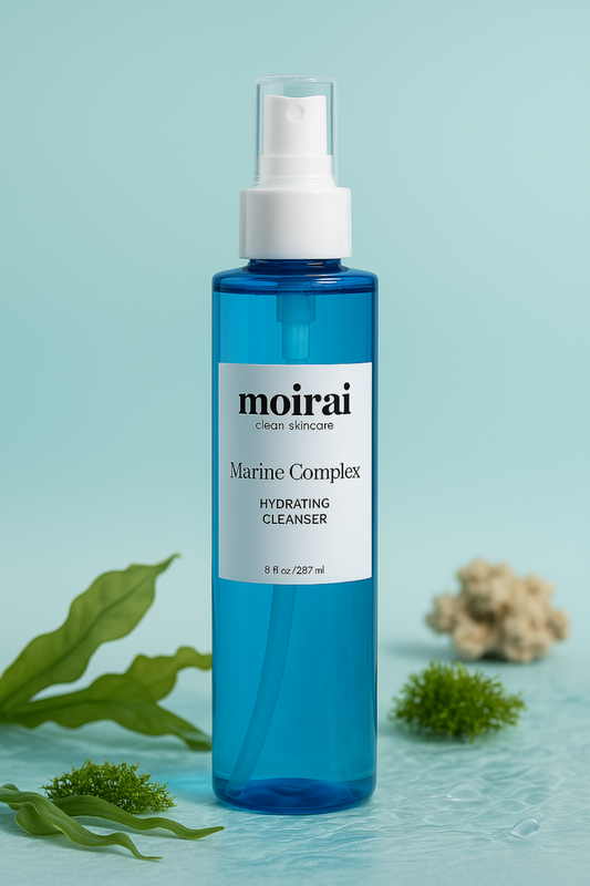 Moirai Marine Complex Hydrating Cleanser bottle styled with seaweed and ocean-inspired elements on a blue background.