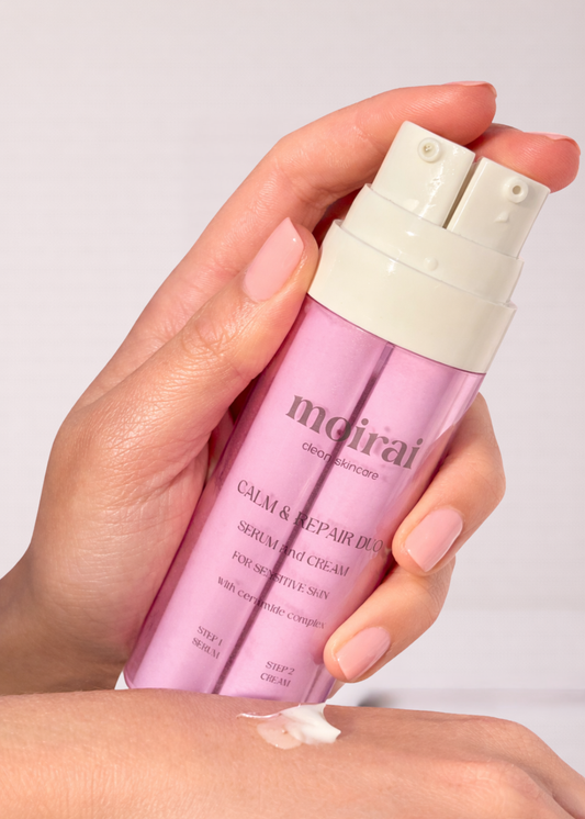 Hand holding Moirai Calm & Repair Duo dual-chamber serum and cream skincare bottle with ceramide barrier repair formula.