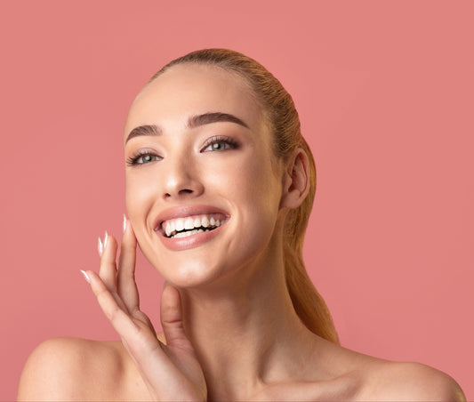 Smiling young woman with radiant, bright looking skin, representing Moirai Citrus-C Brightening Toner with Pink Grapefruit and Vit. C