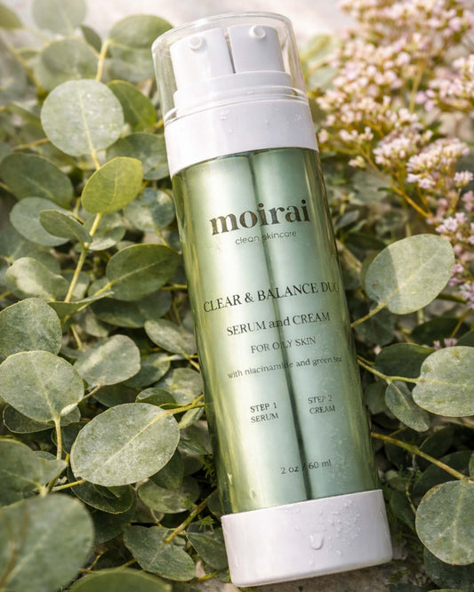 Moirai Clear & Balance Duo dual chamber serum and cream for oily, acne prone skin with niacinamide and green tea on botanical background