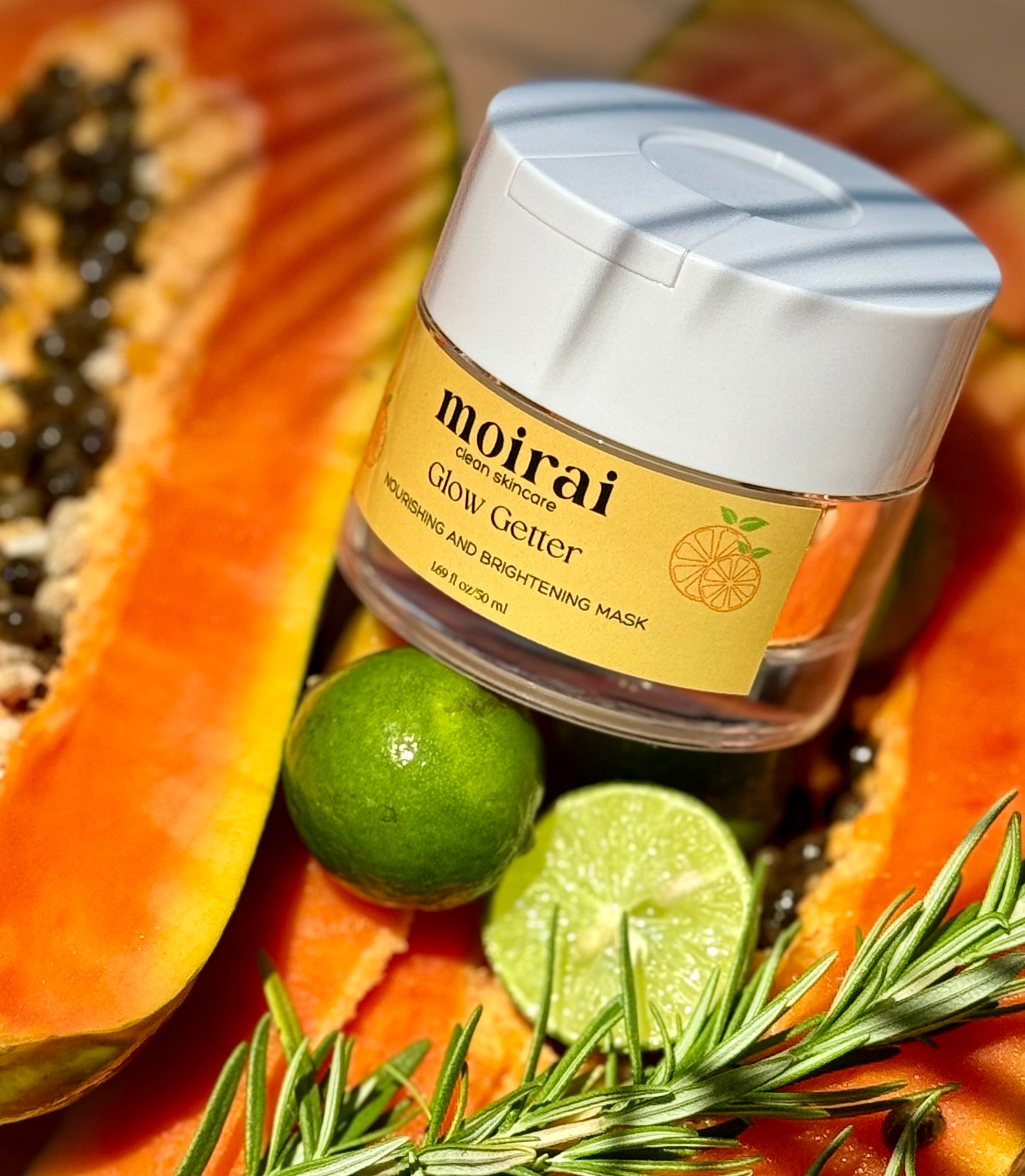 Moirai Glow Getter Nourishing and Brightening Mak jar styled with papaya, lime and rosemary.