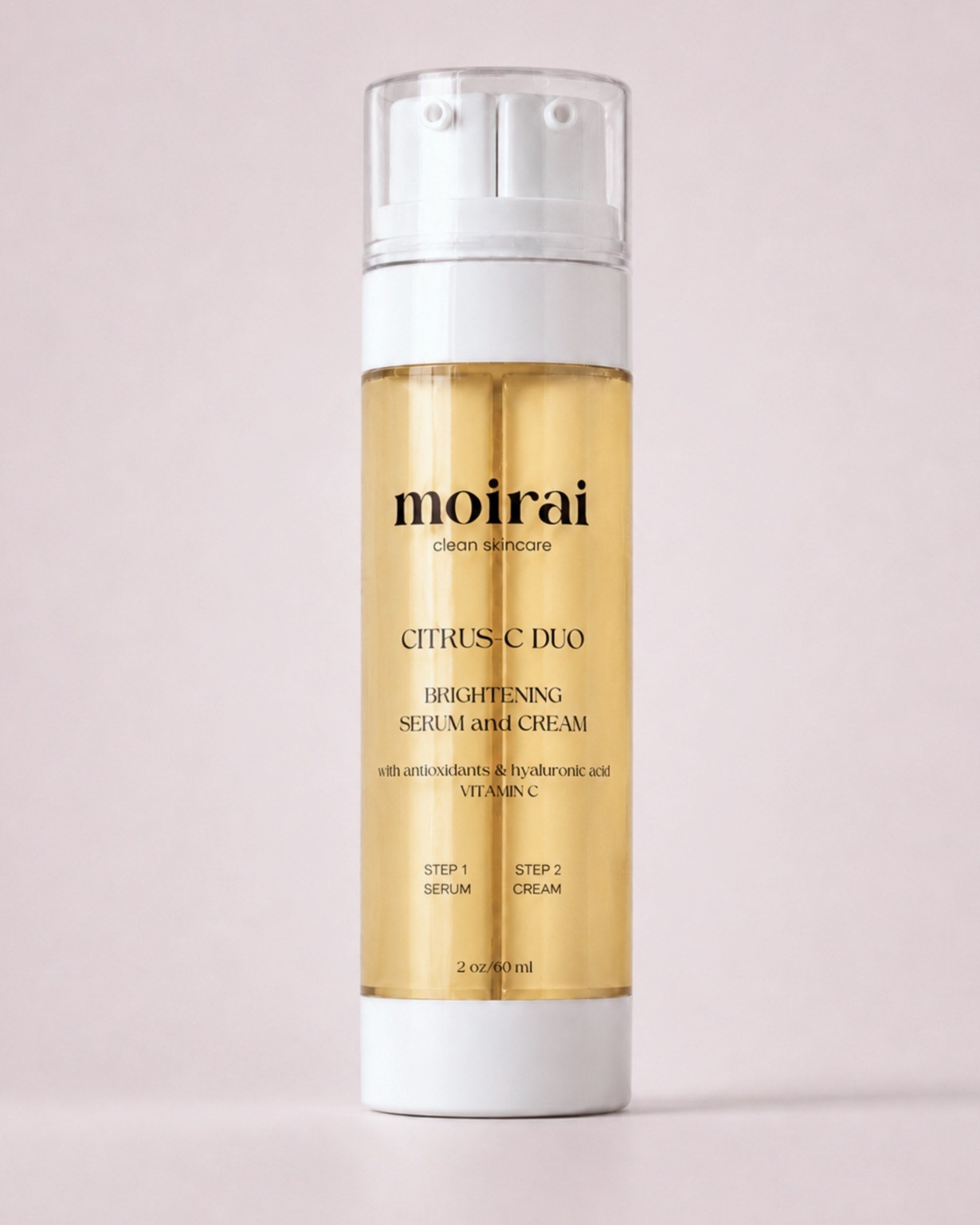 Moirai Citrus C Duo brightening serum and cream in a yellow dual-chamber skincare bottle on a soft pink background