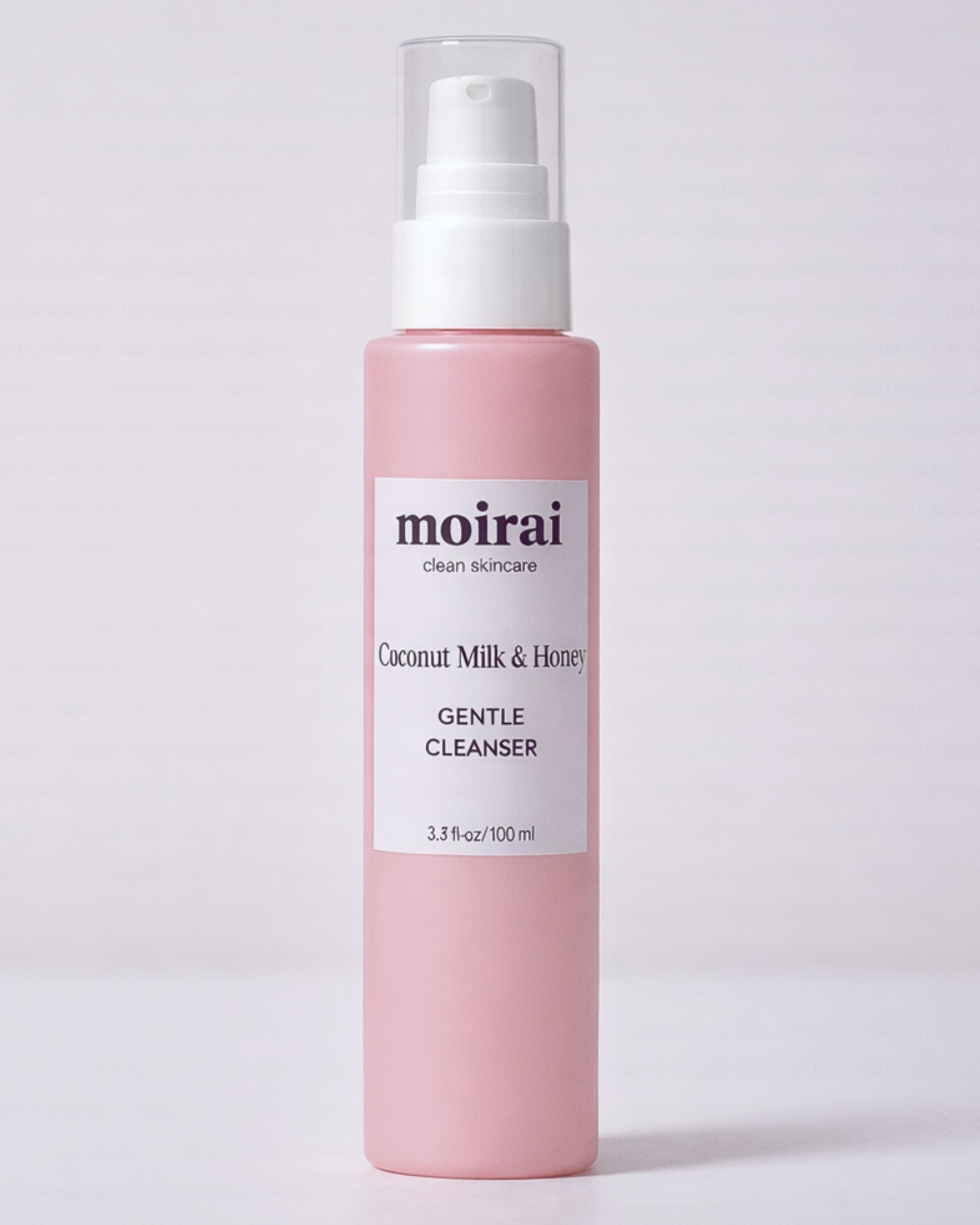 Moirai Coconut Milk & Honey Gentle Cleanser pink bottle on light background