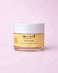 Moirai Glow Getter Nourishing and Brightening Moirai Glow Getter Nourishing and Brightening Mask in a clear jar with white lid on a soft blush pink background.