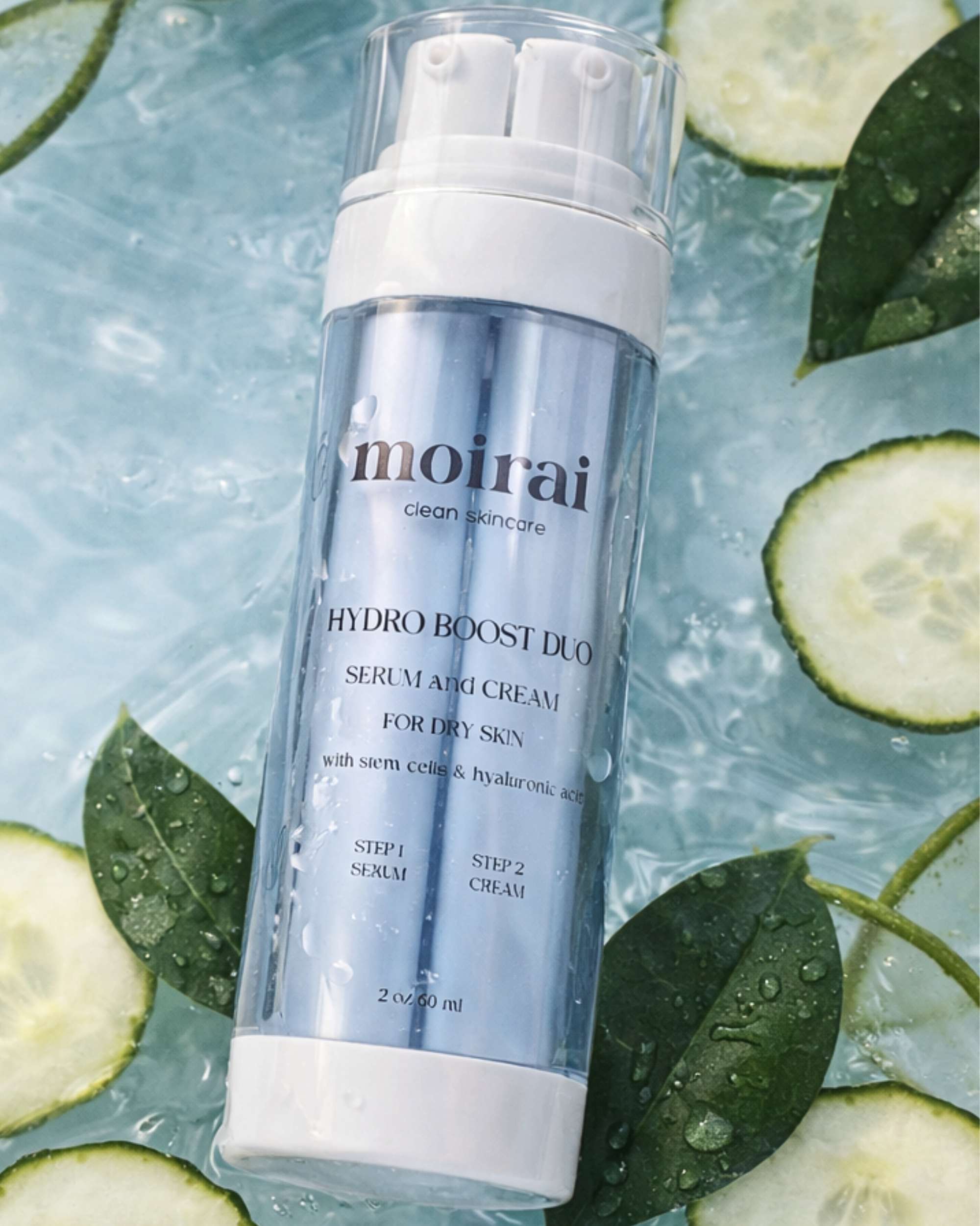 Moirai Hydro Bost Duo hydrating serum and cream with hyaluronic acid surrounded by cucumber slices on a water background