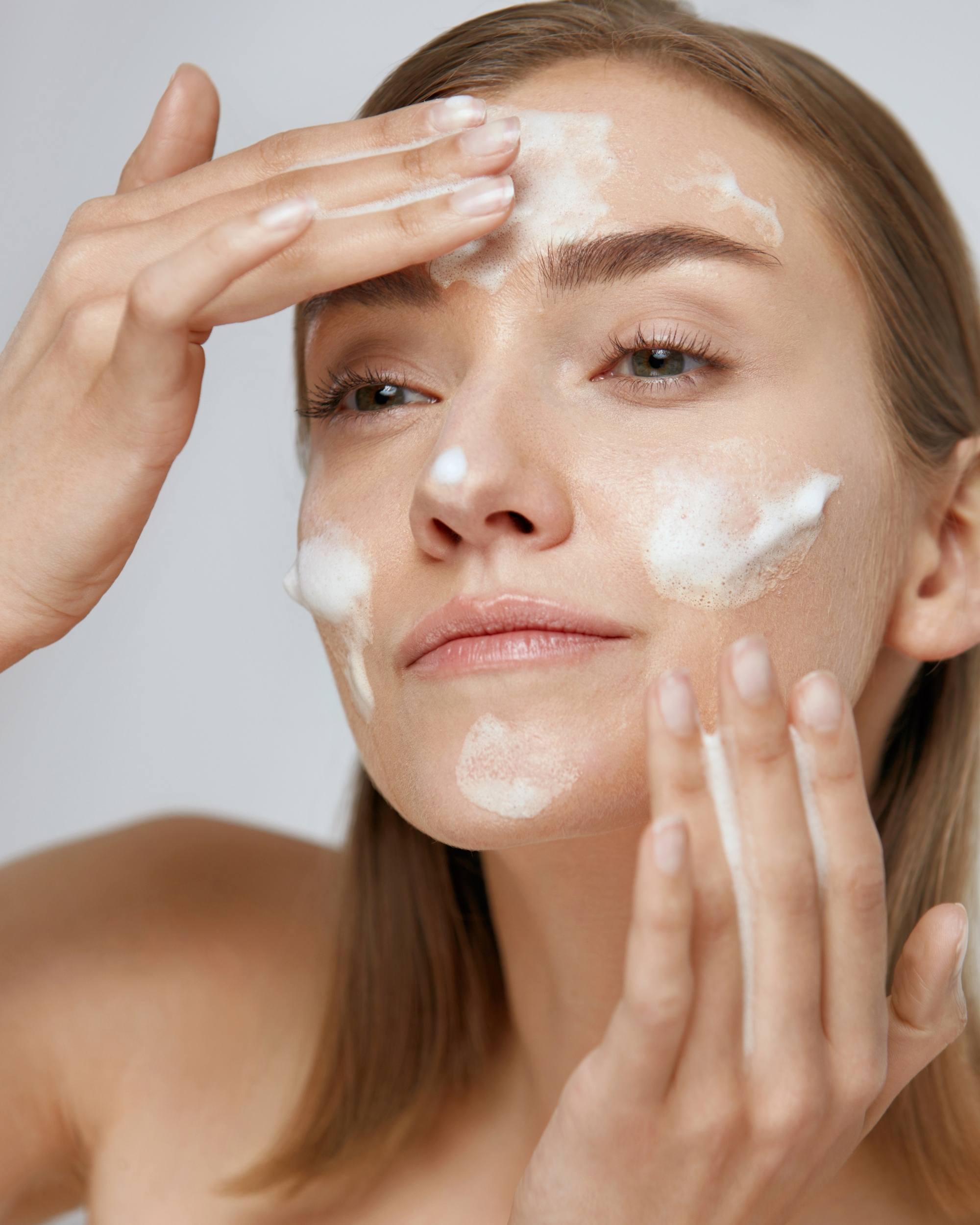 Woman applying Moirai Marine Complex Hydrating Cleanser gentle face cleanser
