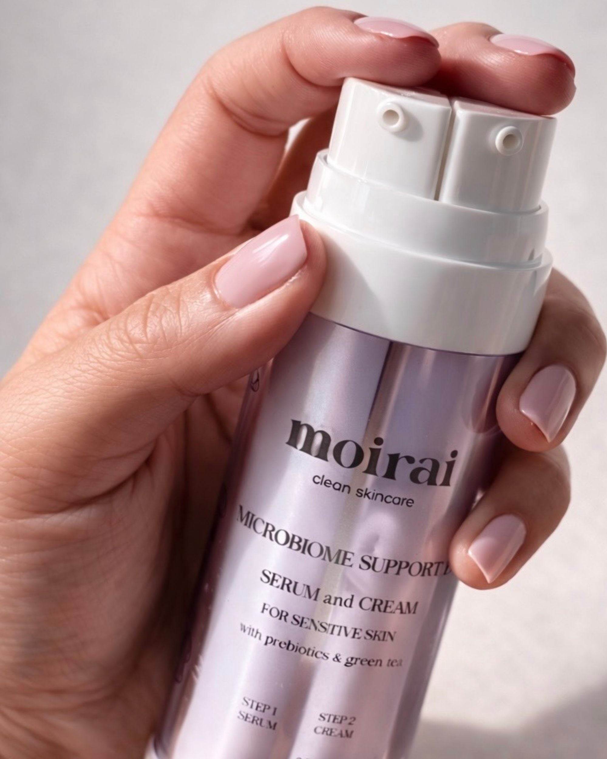 Moirai Microbiome Support Duo dual-delivery probiotic serum and cream held in hand