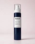 Moirai Super Fruits Refreshing and Nourishing Toner in a deep navy-blue bottle with white pump on a soft blush background