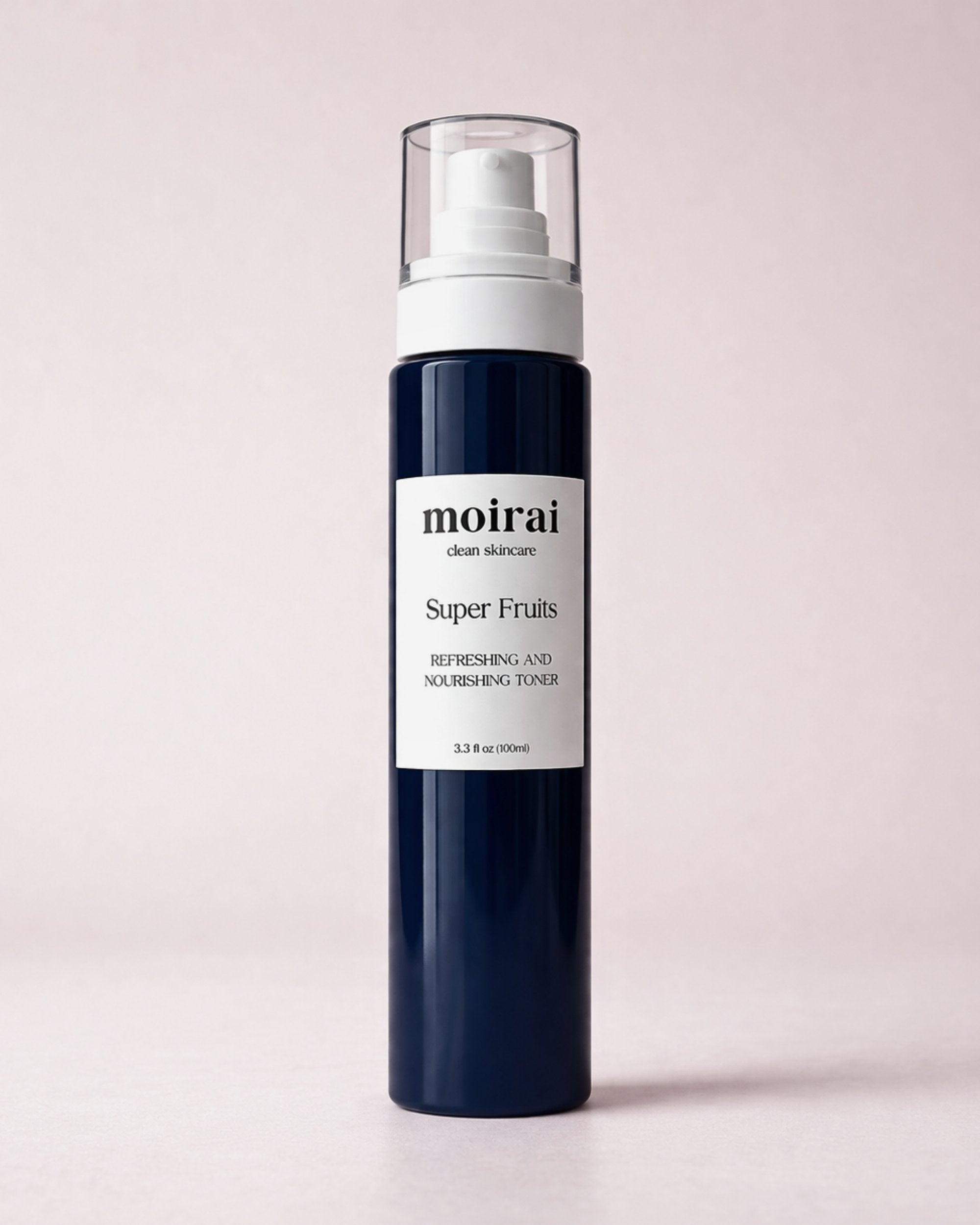 Moirai Super Fruits Refreshing and Nourishing Toner in a deep navy-blue bottle with white pump on a soft blush background