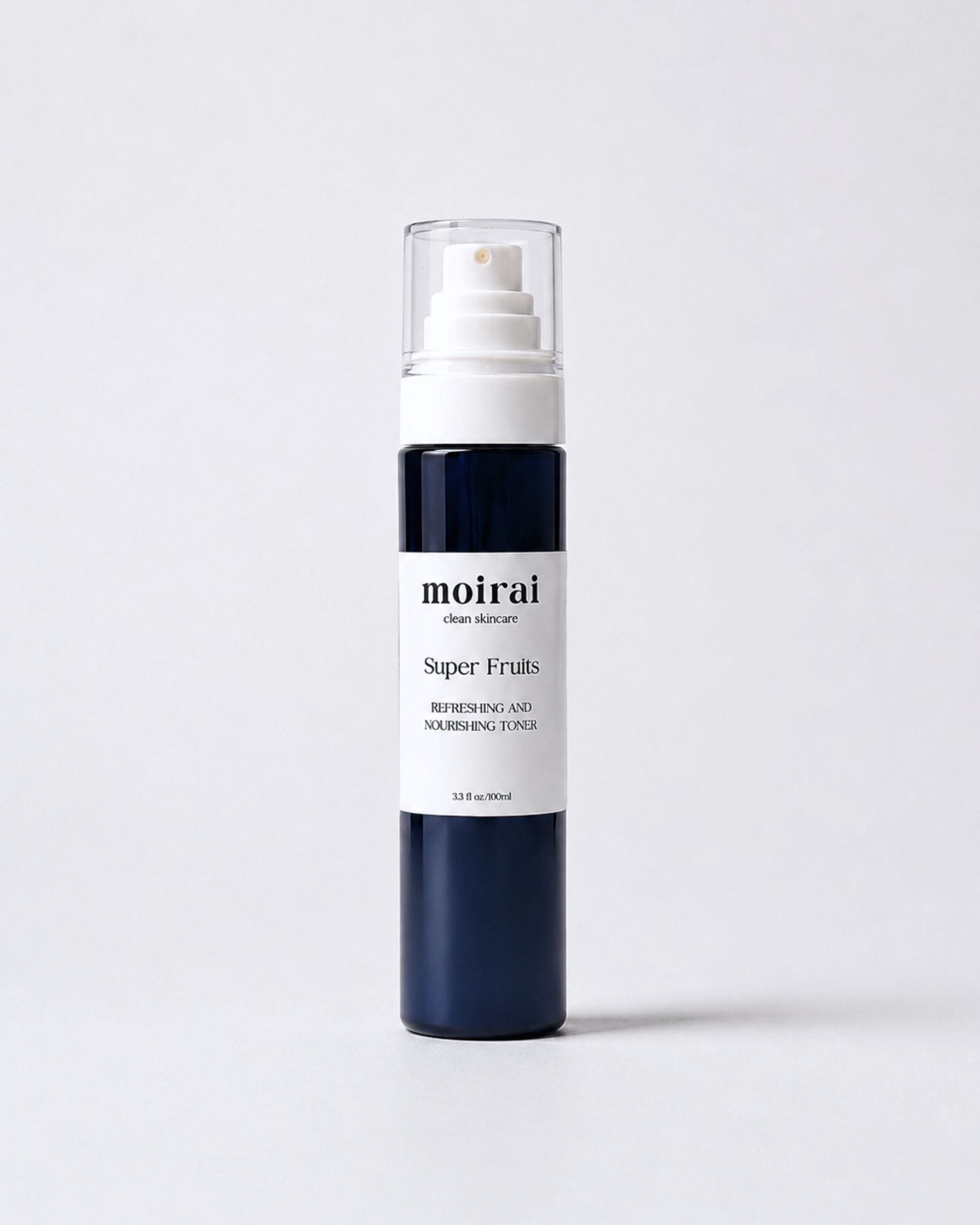 Moirai Super Fruits Refreshing and Nourishing Toner in a deep navy-blue bottle with white pump on a soft blush background