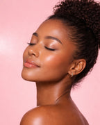 Glowing skin model on soft pink background representing hydration from Moirai Watermelon & Cucumber Hydrating Toner